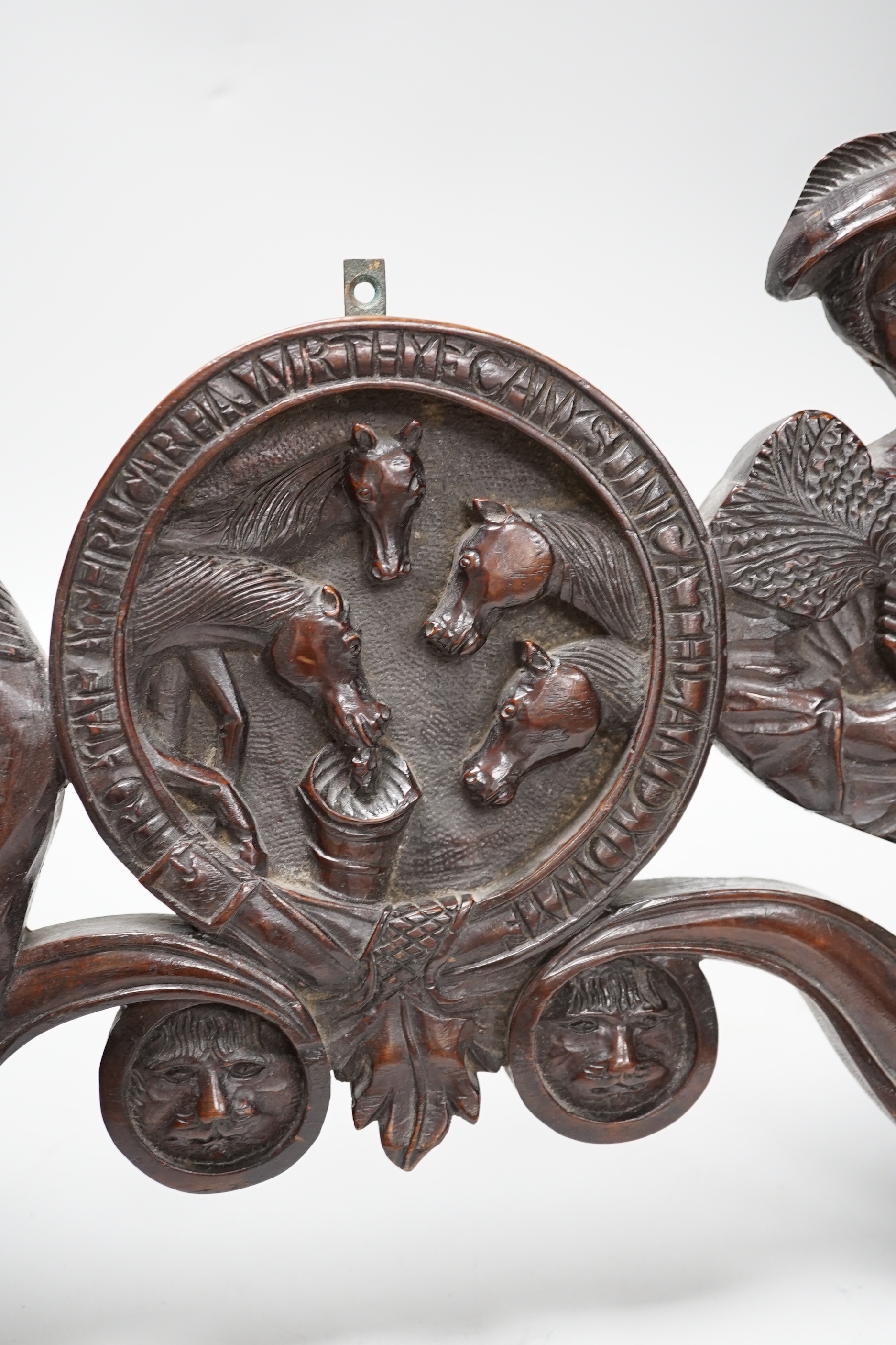 A 19th century carved figural door pediment, 46cm wide